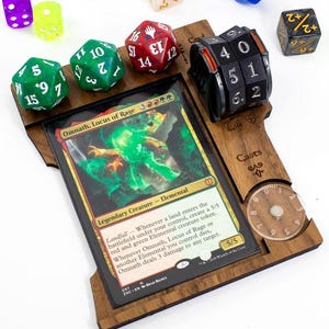 May include: A wooden game board with a Magic: The Gathering card, "Omnath, Locus of Rage", dice, and a counter. The board has a life counter, a card counter, and a dice rolling area.