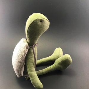 May include: A set of three ceramic mugs with a speckled, matte finish. The mugs are in shades of cream, light gray, and dark gray. Each mug has a simple, minimalist design, perfect for coffee or tea.