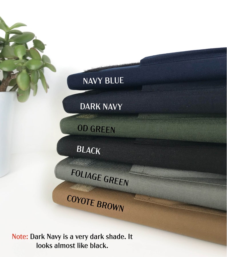 May include: A stack of fabric samples in various colors, including Navy Blue, Dark Navy, OD Green, Black, Foliage Green, and Coyote Brown. Each sample has a label with its color name. The text at the bottom states that Dark Navy is a very dark shade.