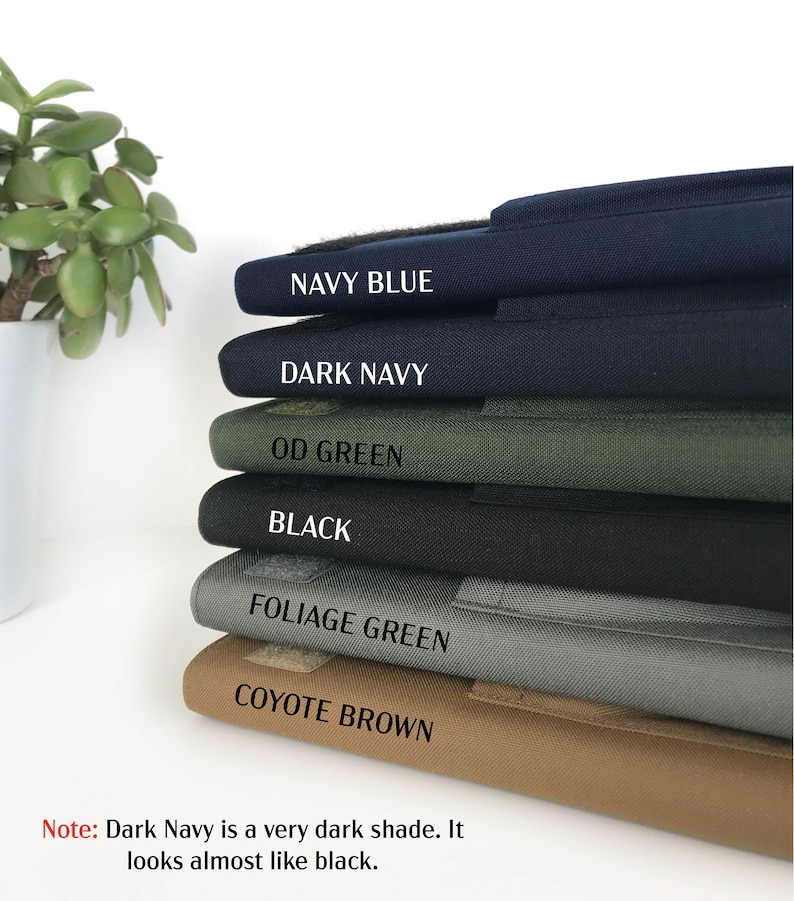 May include: A stack of fabric samples in various colors, including Navy Blue, Dark Navy, OD Green, Black, Foliage Green, and Coyote Brown. Each sample has a label with its color name. The text at the bottom states that Dark Navy is a very dark shade.