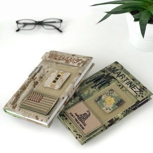 May include: Two camouflage-patterned notebooks with personalized name patches. One notebook features an American flag patch and the name "WILLIAMS." The other notebook displays the name "MARTINEZ" and a "Don't Tread on Me" patch. Both have pen holders.