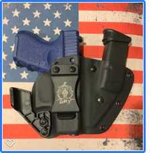 May include: A black holster with a gun inside. The holster has a belt clip and a magazine holder. The holster is made of a durable material and is designed to protect the gun and keep it secure.