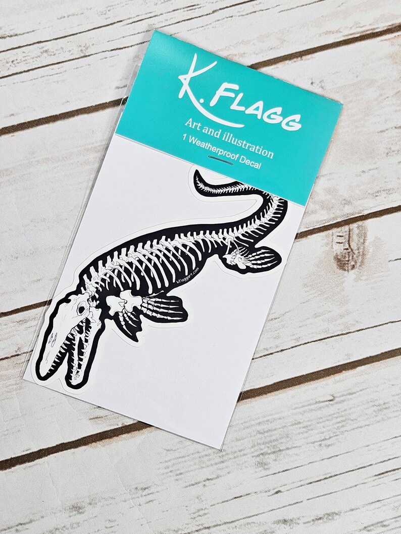 May include: A black and white weatherproof decal of a plesiosaur skeleton. The decal is packaged in a clear plastic sleeve with a turquoise backing card that reads "K. Flagg Art and Illustration 1 Weatherproof Decal".