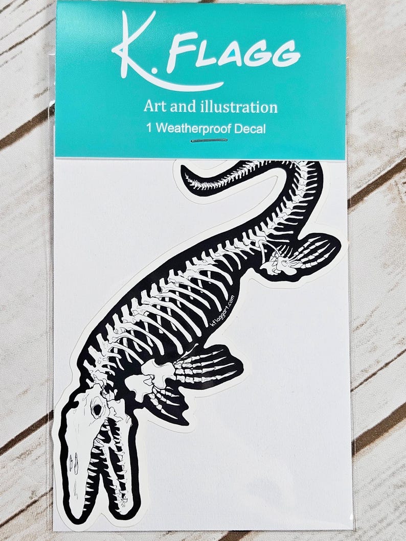 May include: A black and white sticker featuring a skeleton of a prehistoric marine reptile. The sticker is packaged in a clear plastic sleeve with a turquoise background and the text "K. FLAGG Art and illustration 1 Weatherproof Decal".