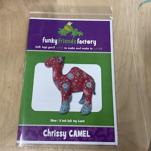 May include: A pattern for a 11 inch soft toy camel named Chrissy Camel. The pattern is from Funky Friends Factory and features a red, blue, and white patterned camel.