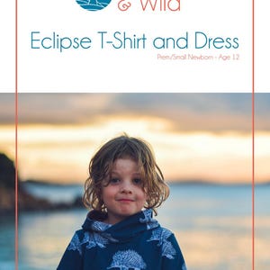 May include: A child wearing a blue t-shirt with a white hedgehog print. The t-shirt has a high neckline and short sleeves. The child is standing in front of a body of water with a sunset in the background. The text "Waves & Wild" and "Eclipse T-Shirt and Dress" is visible at the top of the image. The text "Prem/Small Newborn - Age 12" is also visible.
