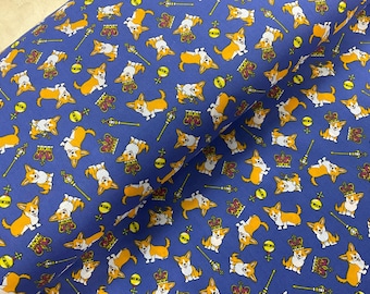 May include: Blue fabric with a repeating pattern of orange and white corgi dogs, crowns, scepters, and yellow orbs. The corgis are in various poses. This fabric is suitable for sewing projects.