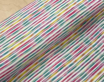 May include: Close-up of a fabric with a diagonal striped pattern. The stripes alternate between white, pink, teal, yellow, and purple. The fabric is folded, showing the texture and pattern of the material.