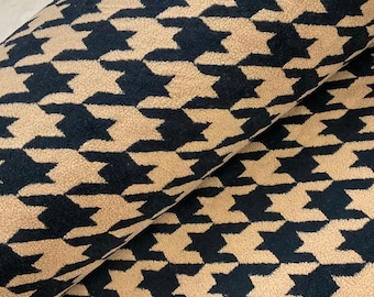May include: Black and tan houndstooth patterned fleece fabric.