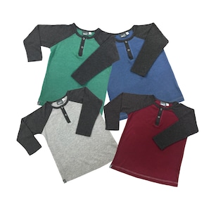 May include: Four long-sleeved shirts with contrasting colored sleeves. The shirts are green, blue, gray, and red. Each shirt has a single button placket.