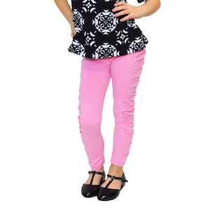 Girls Pink Ruched Ruffled Leggings and matching Bow Headband in Infant, Toddler, Little Girl and Big Girl sizes.