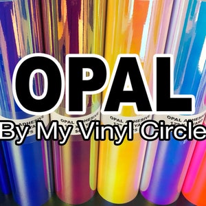 May include: Assortment of iridescent opal adhesive vinyl rolls in various colors, including blue, purple, yellow, and pink. The rolls are labeled "OPAL ADHESIVE 12" x 50 YARD" and "By My Vinyl Circle".