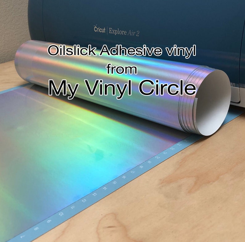 May include: A roll of iridescent oil slick adhesive vinyl, with the text "Oilslick Adhesive vinyl from My Vinyl Circle" printed on the roll.