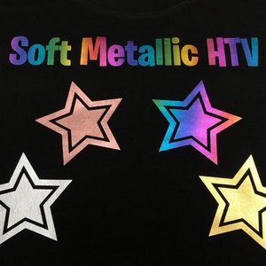 May include: Four star-shaped iron-on heat transfer vinyl patches in different colors: pink, rainbow, silver, and gold. The text "Soft Metallic HTV" is printed above the patches.