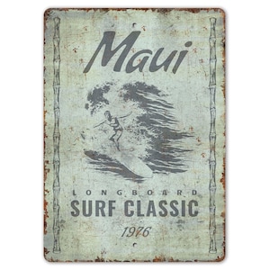 May include: Vintage metal sign with a distressed finish, featuring the word "Maui" above a surfer riding a wave. The sign reads "Longboard Surf Classic 1976" in gray lettering, with bamboo-like borders.