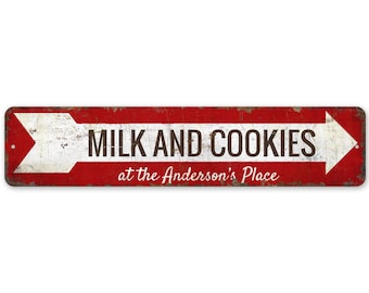 May include: A red and white metal sign with a white arrow pointing to the right. The sign reads "Milk and Cookies at the Anderson's Place".