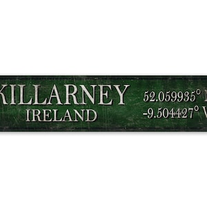 May include: A green metal sign with the text "KILLARNEY IRELAND" and the coordinates "52.059935° N -9.504427° W".