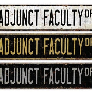 May include: Three vintage-style metal signs with the text "Adjunct Faculty Dr." in black, gold, and silver lettering on a black background.