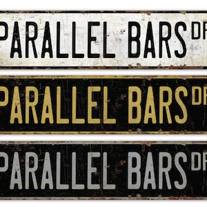 May include: Three vintage-style metal signs with the text "PARALLEL BARS DR" in black, gold, and white lettering on a black background.