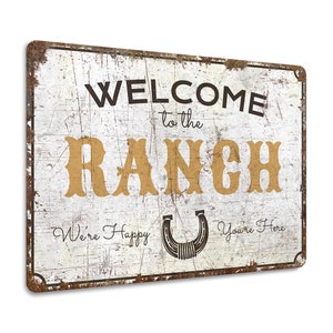 a metal sign that says welcome to the ranch