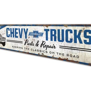 a metal sign that says chevy trucks past and repair