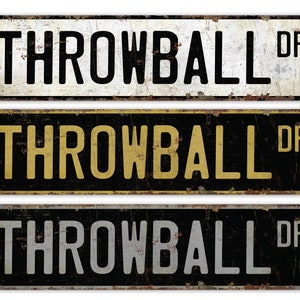 May include: Three vintage-style metal signs with the text "THROWBALL DR" in black, yellow, and white lettering on a black background.