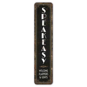 May include: A black and gold vintage-style metal sign with the text "Speakeasy" in white lettering. The sign also includes the text "Welcome Flappers & Gents".
