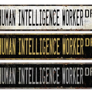 May include: Three vintage-style metal signs with the text "HUMAN INTELLIGENCE WORKER DR" in black, gold, and silver lettering on a black and white background.