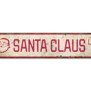 a santa claus tin sign on a white background