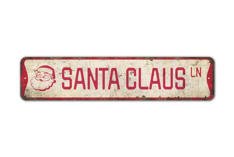 a santa claus tin sign on a white background