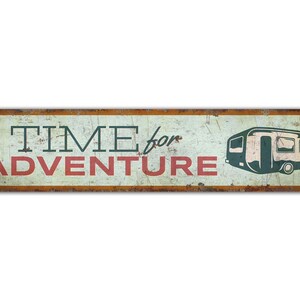May include: A vintage-style metal sign with a distressed, rusty look. It features the text "TIME for ADVENTURE" in red and black lettering, with a silhouette of a camper van in the background.