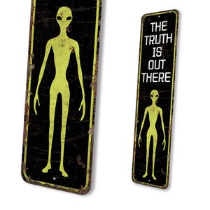 a sign with a picture of an alien on it