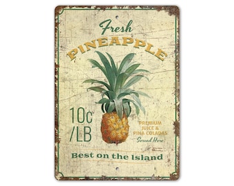 May include: Vintage-style metal sign with a distressed background featuring a pineapple illustration and the text "Fresh Pineapple 10c/LB Premium Juice & Pina Coladas Served Here Best on the Island".