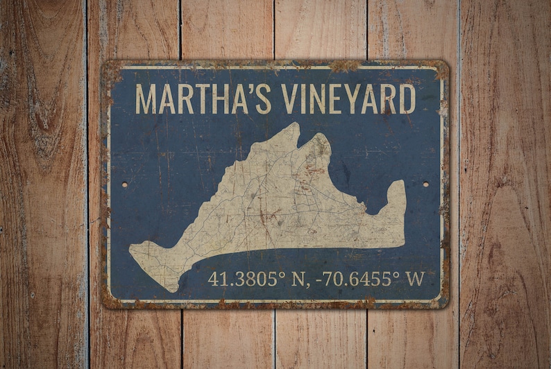 May include: A blue and white vintage-style metal sign with the text "Martha's Vineyard" and a map of the island. The coordinates "41.3805&deg; N, -70.6455&deg; W" are printed below the map.