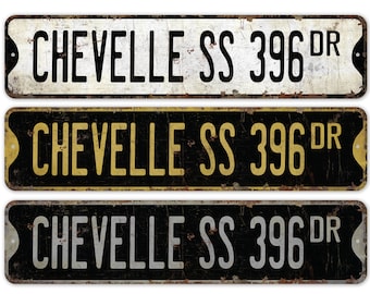 May include: Three vintage-style metal signs with the text "Chevelle SS 396 DR" in black lettering on a white, black with gold, and black with silver background.