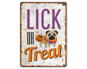 May include: A white metal sign with a distressed look. It features a cartoon pug wearing a purple scarf and holding a pumpkin bucket. The text on the sign reads "Lick or Treat" in orange and purple letters.