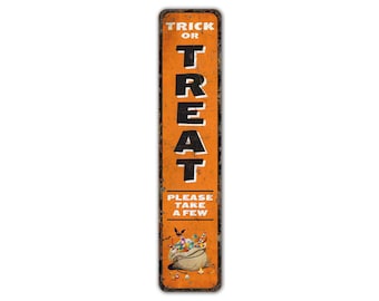 May include: Orange and black metal sign with the text "Trick or Treat" and "Please take a few". The sign features a cartoon illustration of a bag of sweets with bats and other Halloween decorations.