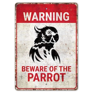 May include: A white metal sign with red text and a black silhouette of a parrot. The sign reads "Warning Beware of the Parrot".