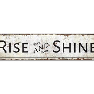 a rusted metal sign that says rise and shine