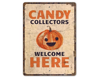 May include: A vintage-style metal sign with a distressed white background and orange text. The sign reads "Candy Collectors Welcome Here" and features a cartoon pumpkin with a smiling face.