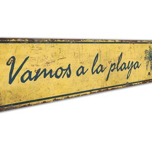 a yellow sign that says vamos a la playa