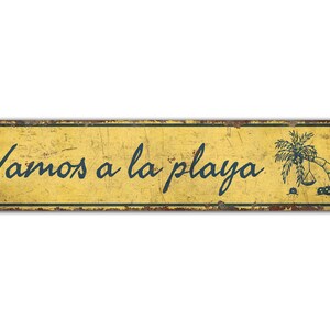 a yellow sign that says vamos a la playa