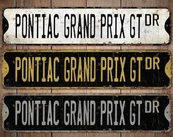 May include: Three vintage-style metal signs with the text "PONTIAC GRAND PRIX GT DR". The signs are rectangular with rounded corners and a distressed finish. The top sign is white, the middle is black with yellow text, and the bottom is black with white text.