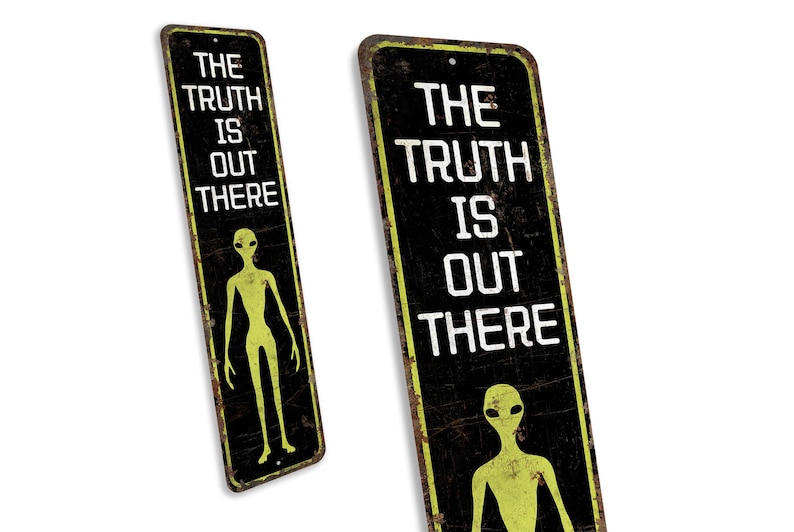 a sign with a picture of an alien and the words the truth is out there