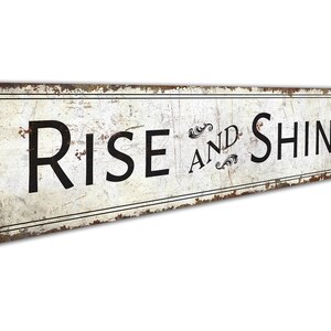 a rusted metal sign that says rise and shine