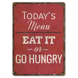 May include: Red metal sign with distressed paint and white text that reads "Today's Menu Eat It or Go Hungry".