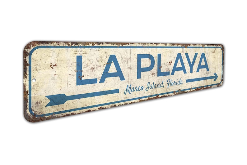 a sign that says la playa with an arrow pointing to the right