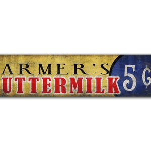 Puede incluir: Un letrero de estilo vintage con fondo amarillo y texto rojo que dice "Farmer's Buttermilk 5¢". El precio está en un círculo azul con texto blanco.