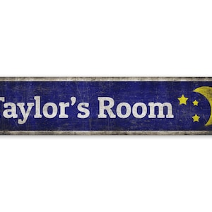 May include: A blue and silver metal sign with the text "Taylor's Room" in white lettering. A yellow crescent moon and stars are on the right side of the sign.