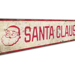 a santa claus sign hanging on a wall